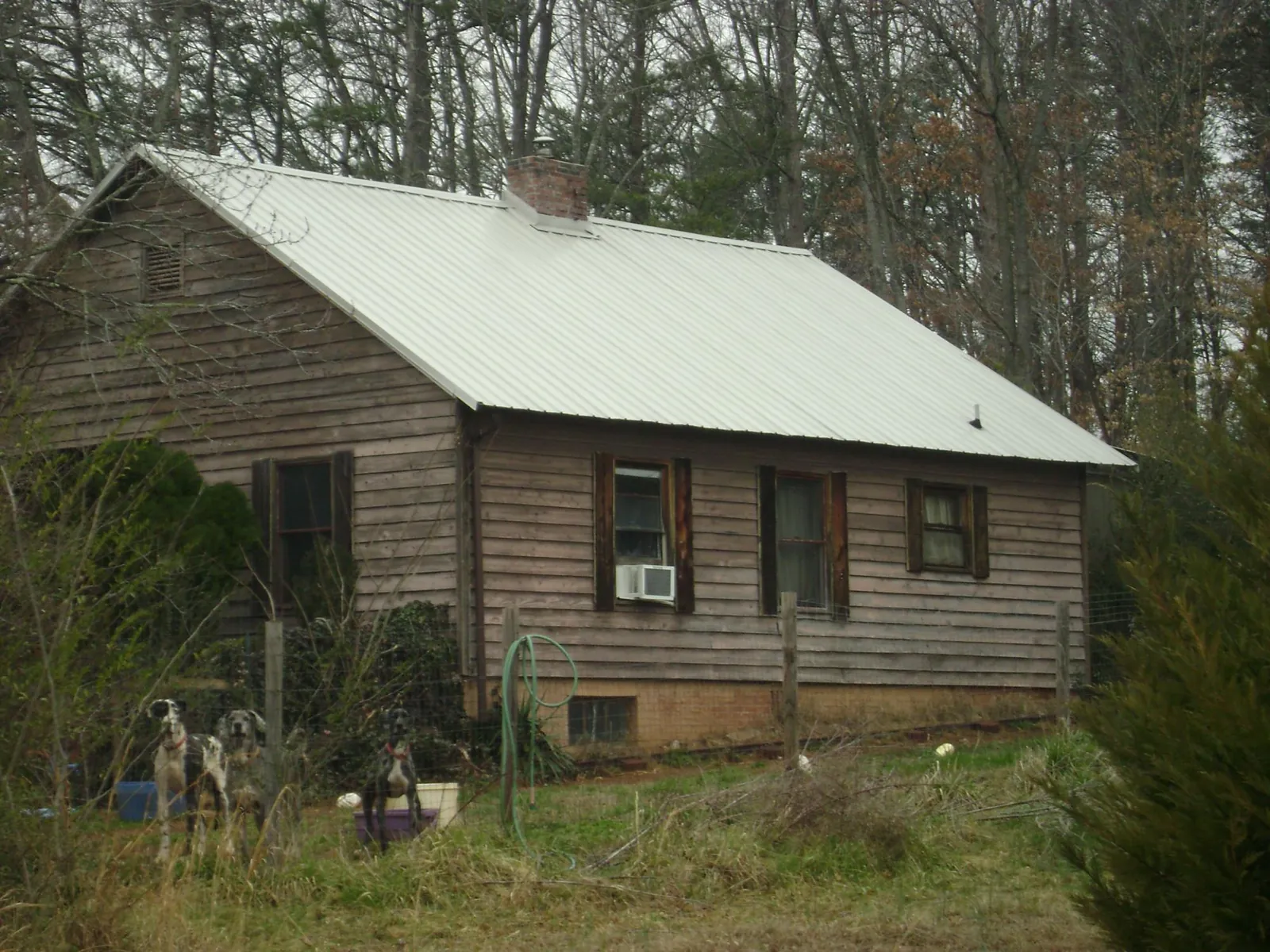 White metal roof on an old wood sided farmhouse, from a Metal Roof Installation job in Boiling Springs
